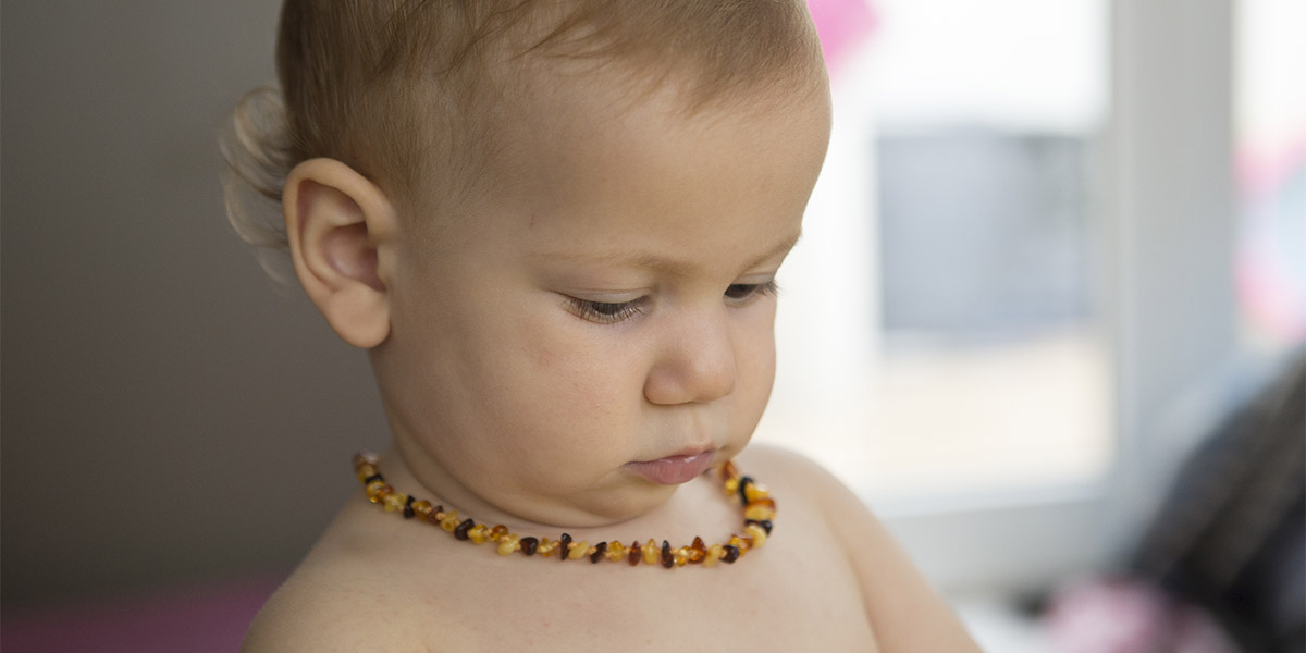 baby toddler wearing amber teeth pain relief neckless