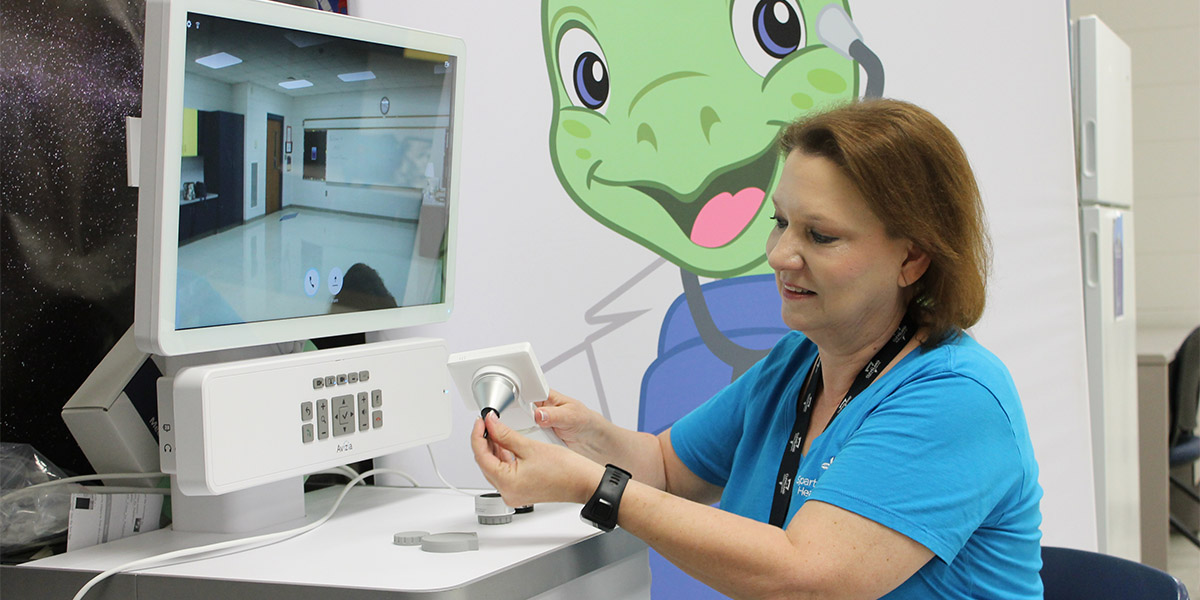 Carol Foil, RN, uses the telehealth equipment