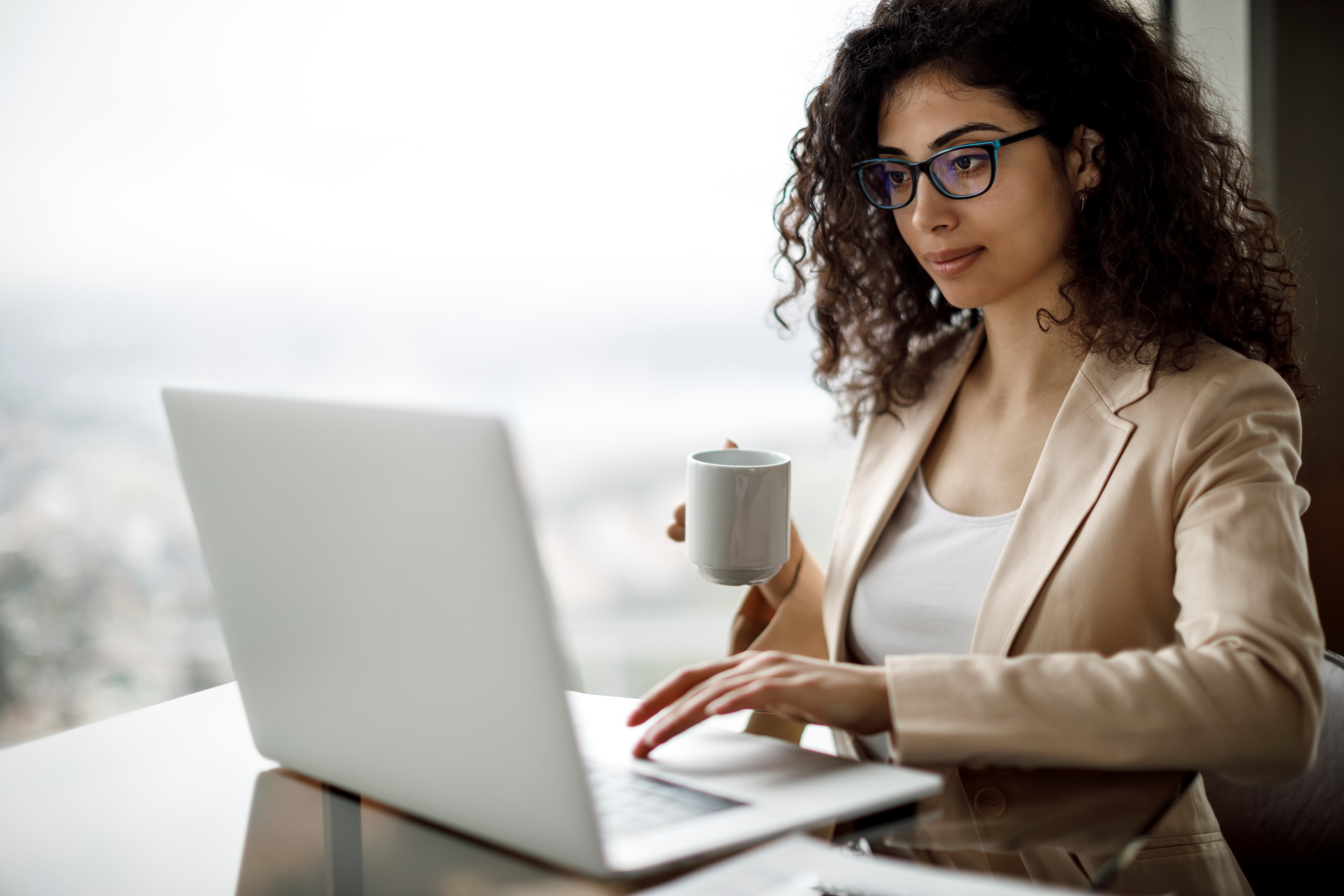 Young businesswoman using laptop at a cafe