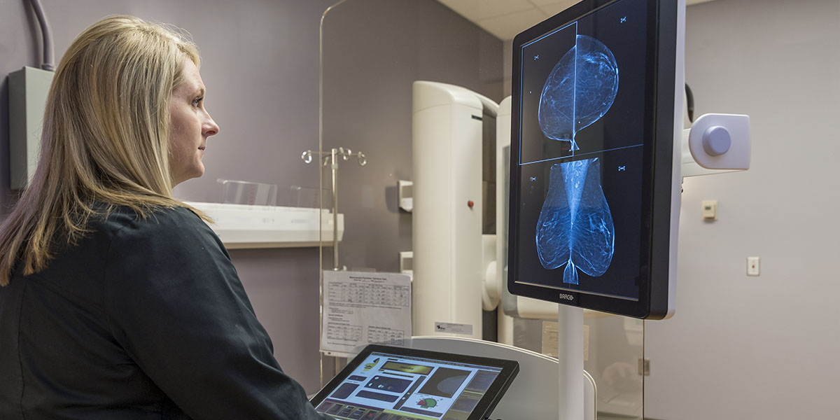 A woman checking the scan made by 3D mammogram technology