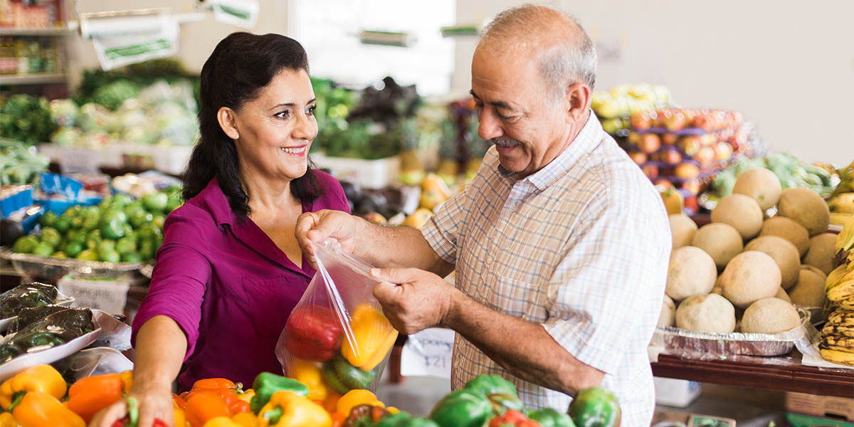 Mature woman and senior man shopping at supermarket