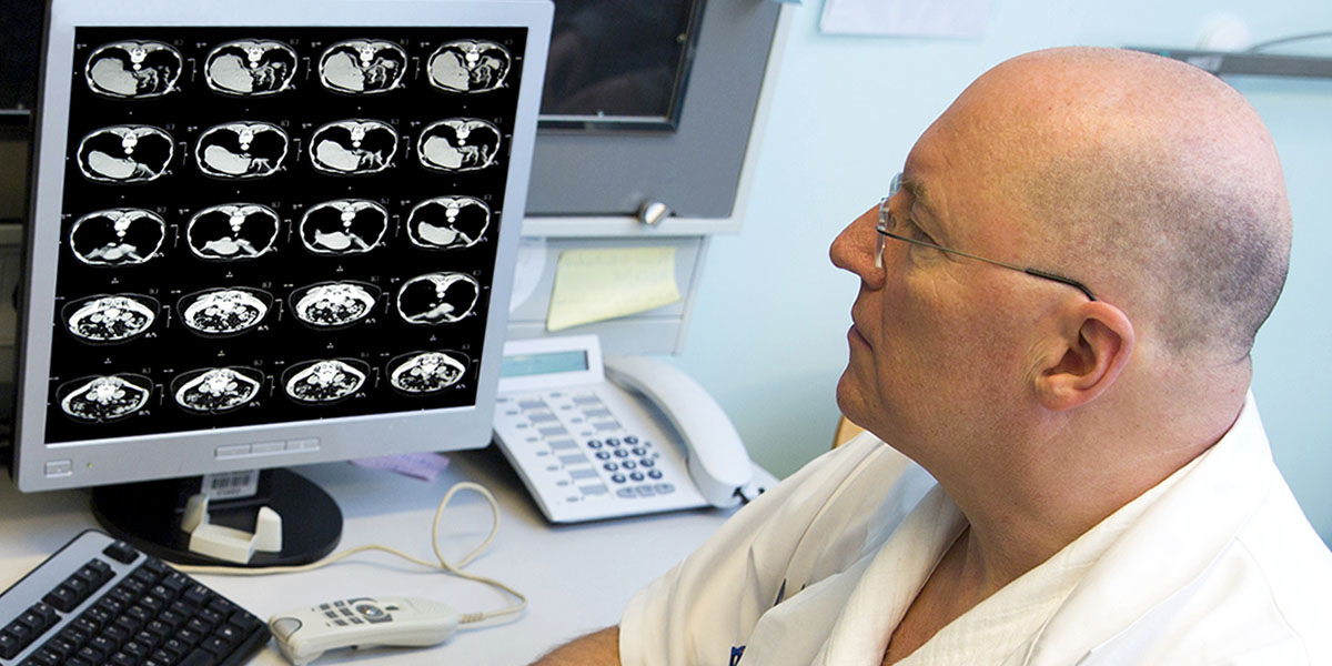 Senior radiologist of Oncology institute is examing MRI scans
