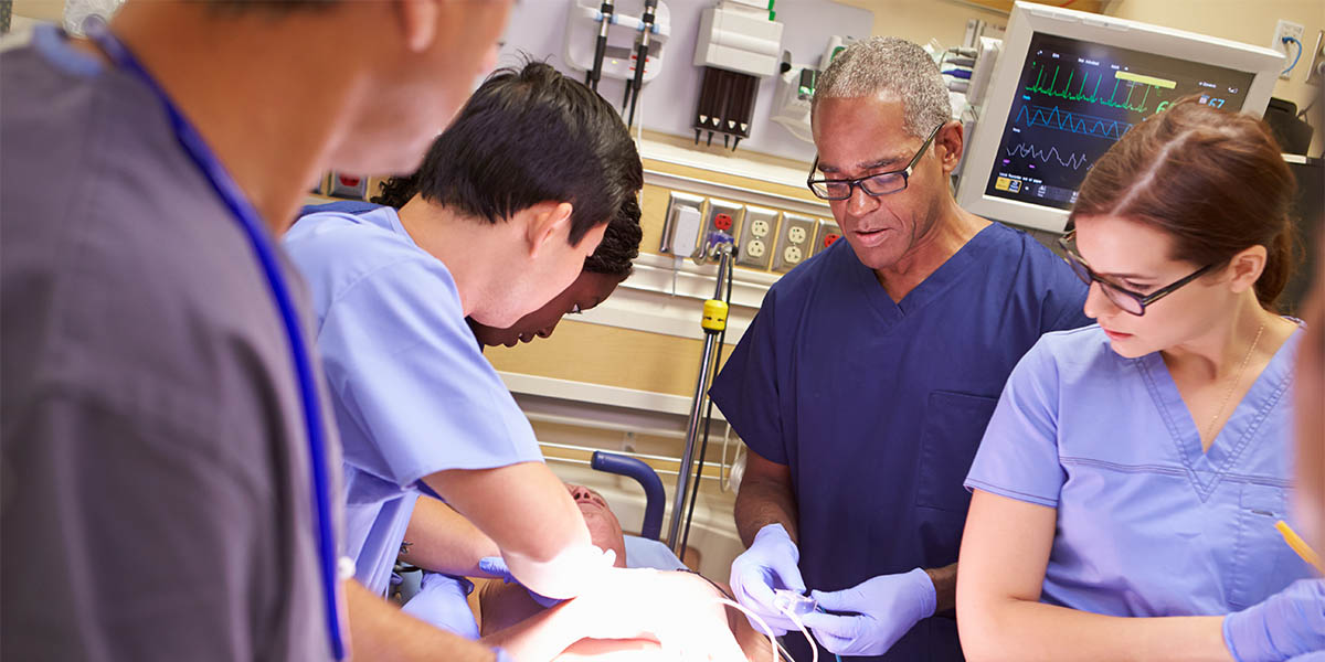 Emergency room medical team working on a patient