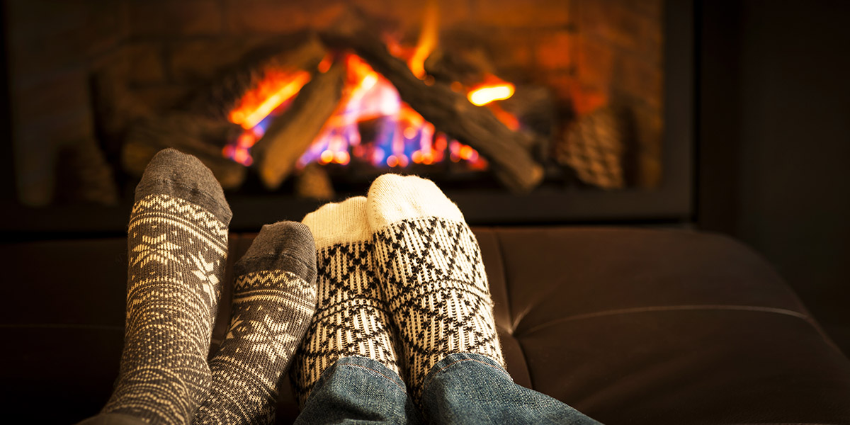 Feet warming by fireplace