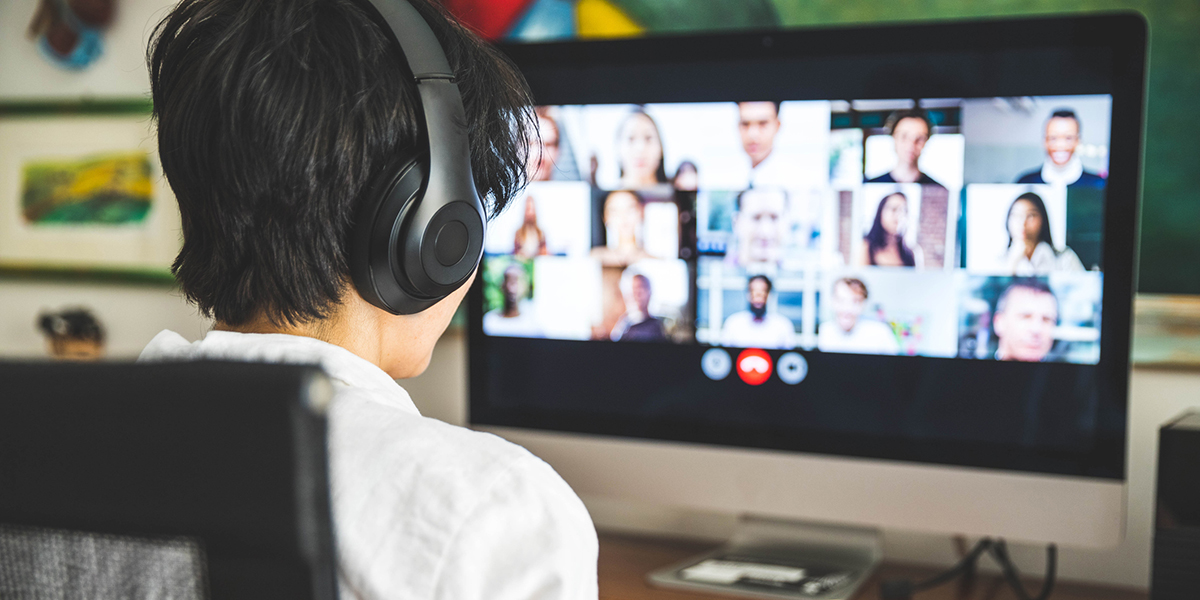 Woman working at home having a video conference with colleagues