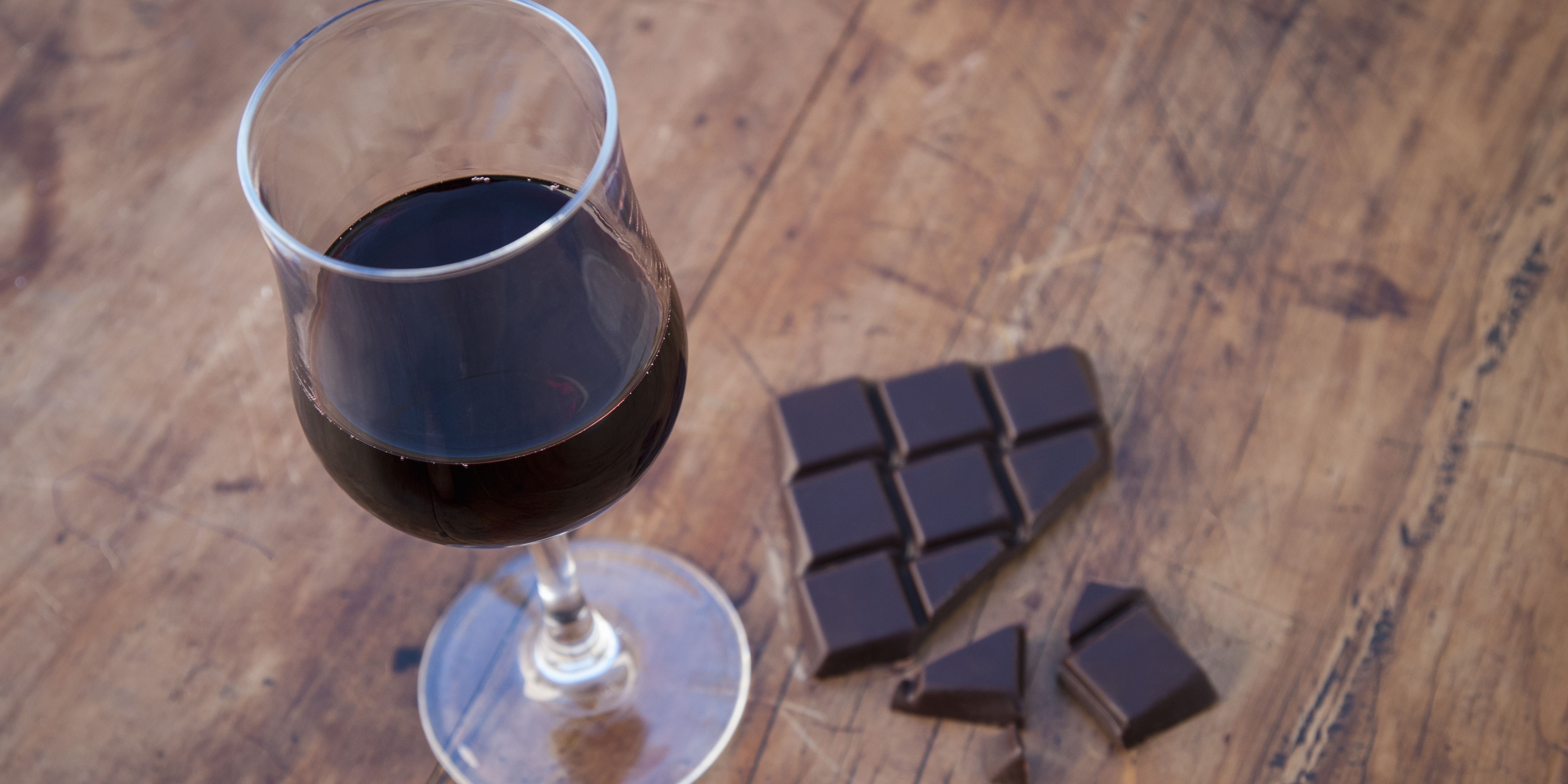 Still life with dark chocolate and red wine