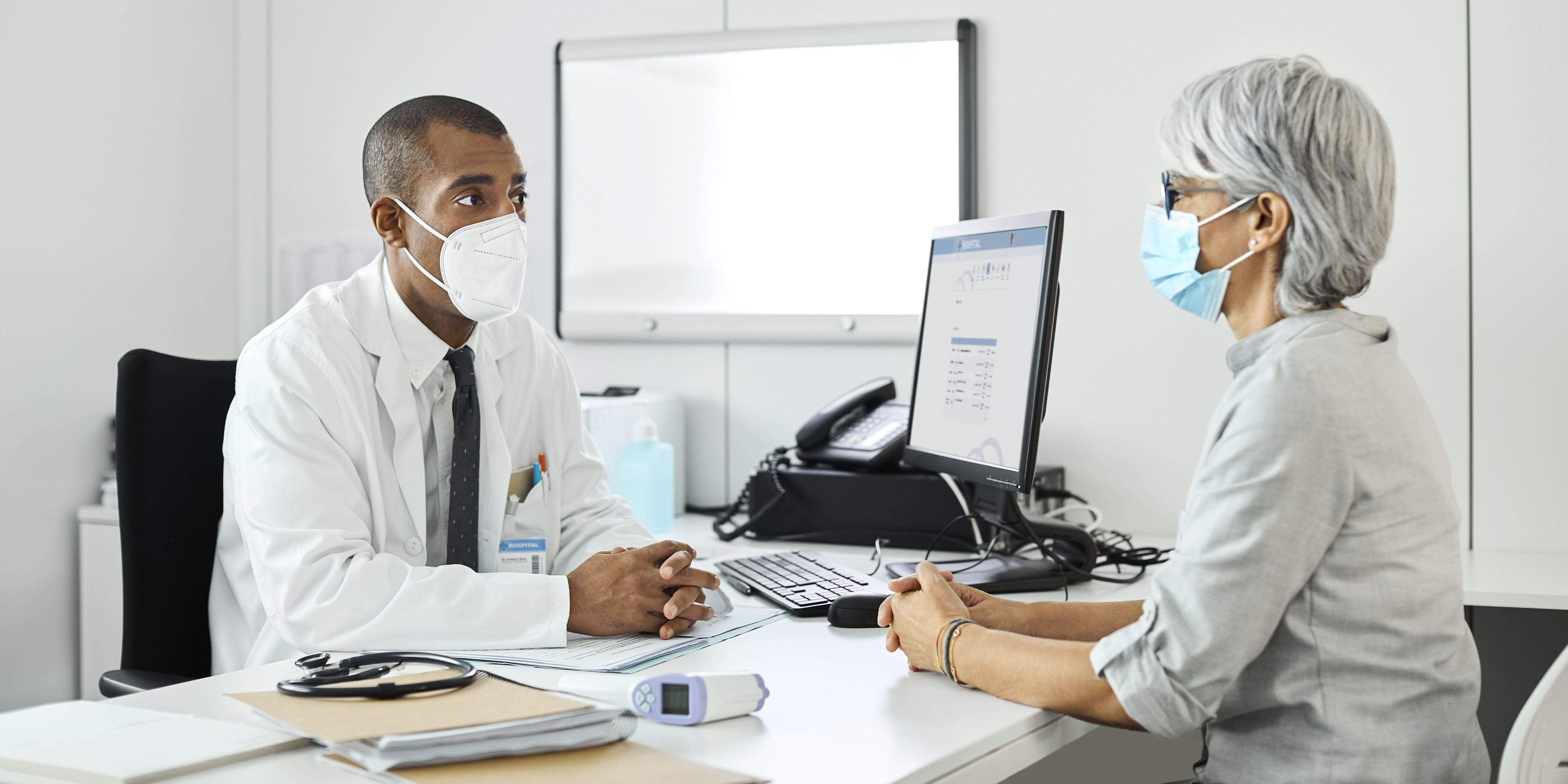 Doctor discussing with woman during COVID-19