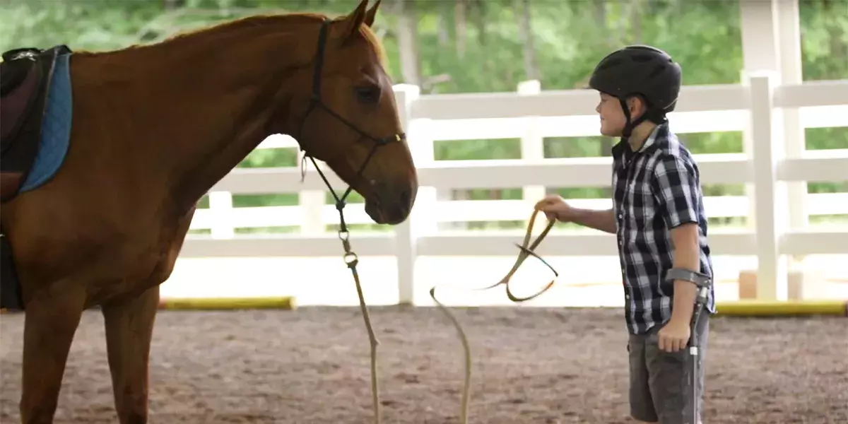 A child with special needs approaches the waiting horse as a part of his Equine Assisted Therapy has become an integral part of the Pediatric Rehabilitation treatment program at Spartanburg Medical Center 