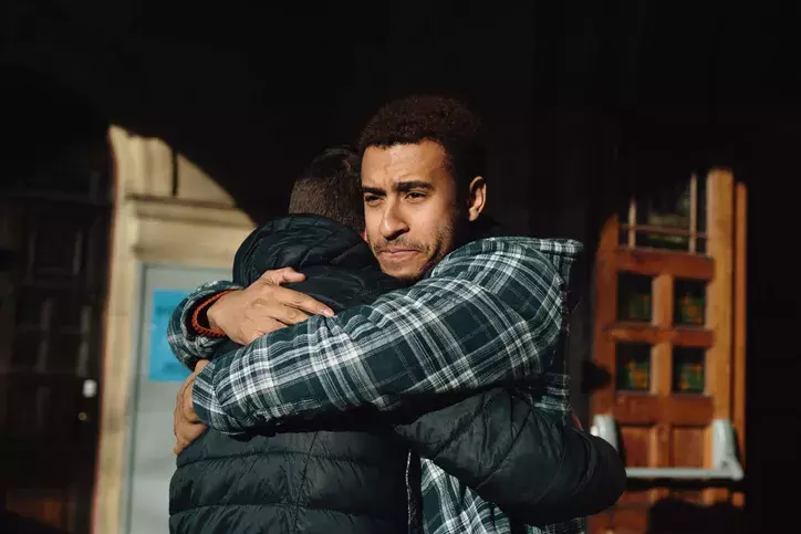 Two men hugging1